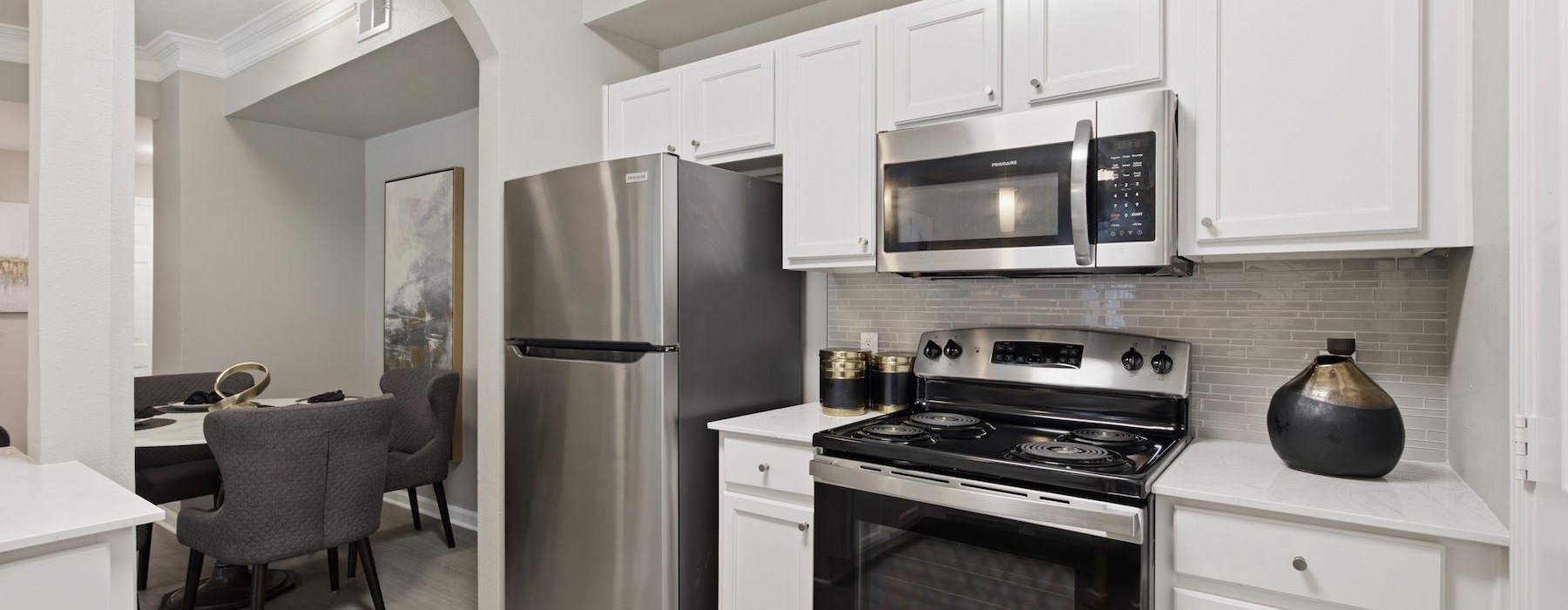 a kitchen with white cabinets