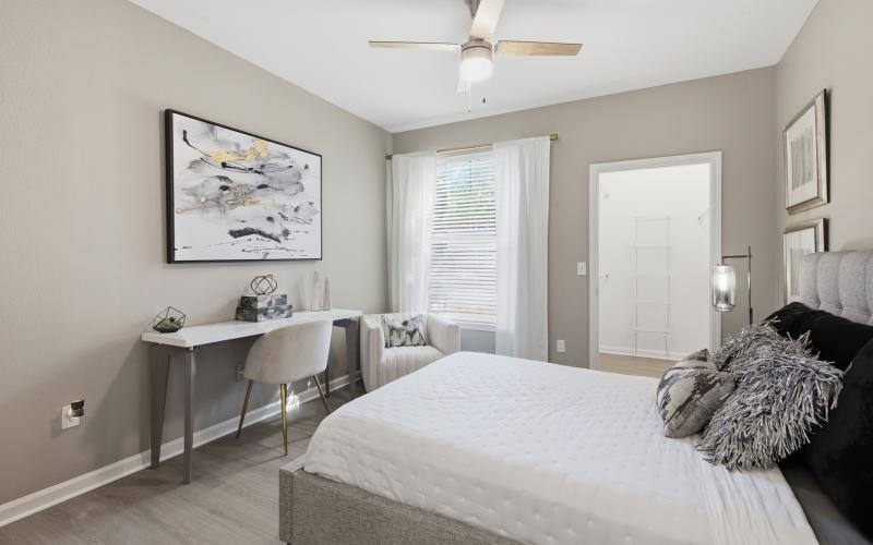 a bedroom with a bed and a desk