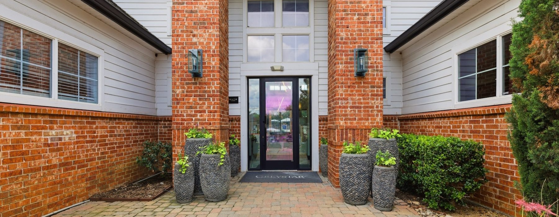 a brick driveway leading to a building