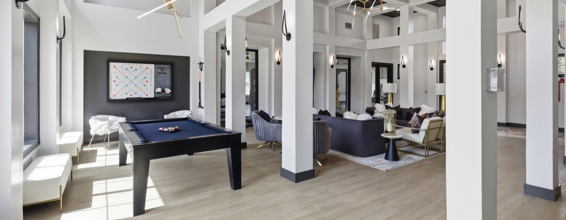 a room with a pool table and chairs