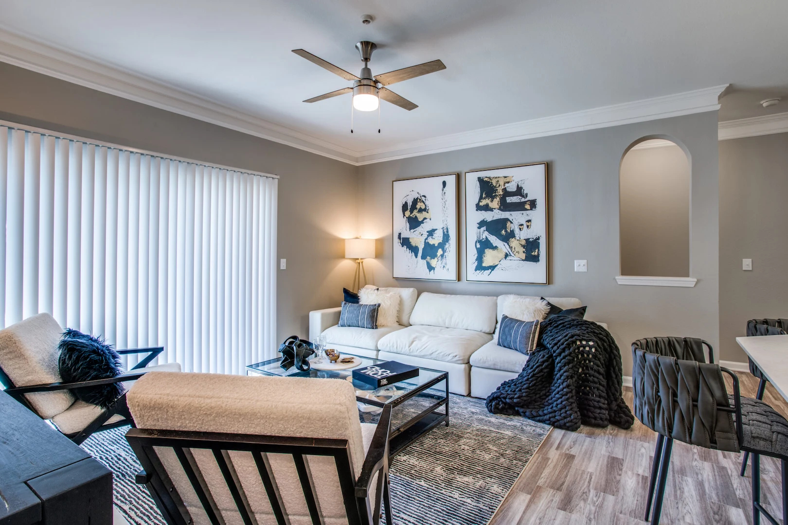 living room with modern furniture, wood style flooring, and ceiling fan